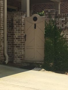 a cat sitting on the ground in front of a door