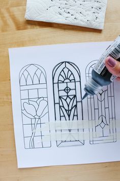 someone is painting stained glass windows on paper