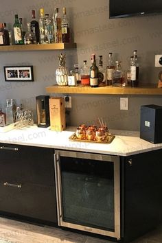 the bar is stocked with liquor bottles and snacks