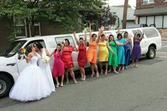 a group of bridesmaids standing in front of a white truck with their arms up