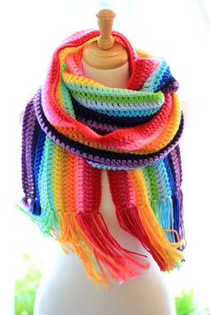 a multicolored crocheted scarf on a mannequin