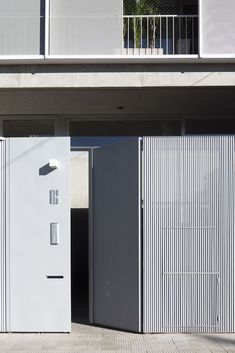 two white doors are open in front of a building