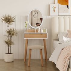 a bedroom scene with focus on the vanity table and mirror, potted plant and bed