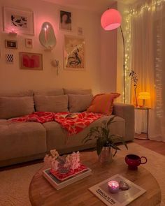 a living room with a couch, coffee table and pictures on the wall