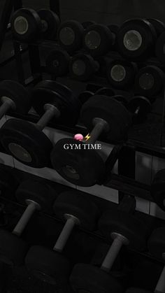 the gym time logo is displayed in front of rows of dumbs and exercise equipment