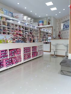 the inside of a store filled with lots of shelves and boxes full of items on display