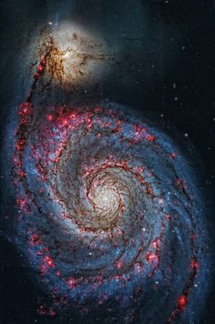 two spiral shaped objects in the sky, one red and one blue with stars on it