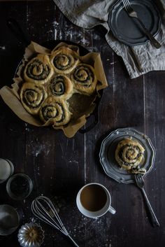 a table topped with pastries next to a cup of coffee