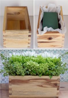 an open wooden box filled with flowers and greenery on top of a wood table