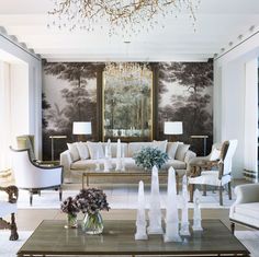 a living room filled with furniture and a chandelier