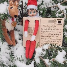 two elf dolls are sitting in the snow next to a sign that says, i missed you