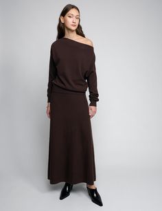 Chocolate brown maxi full skirt with elastic waistband . Styled with matching off-the-shoulder knit top. 50% wool, 50% polyesterElastic encased waistband Total length 39.5"Model is wearing a size S and model’s height is 5.9”Imported Crop Sweater Maxi Skirt, Maxi Skirt Winter 2022, Black Maxi Skirt With Sweater Pregnancy, One Shoulder Knit Top, Brown Maxi Skirt, Maxi Skirt Winter, Skirt Winter, Style Analysis, Full Maxi Skirt