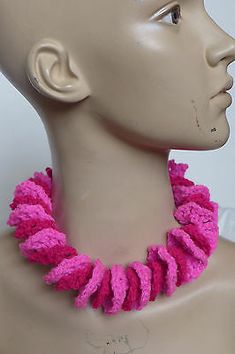 a mannequin head with a pink necklace on it