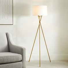 a floor lamp next to a chair in a living room