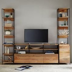 an entertainment center with shelves and a television