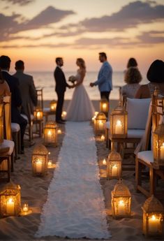 a couple getting married on the beach with candles in front of them and people standing around