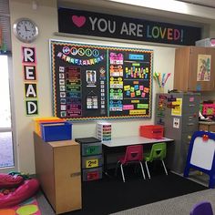 a classroom with desks, chairs and chalkboard on the wall that says you are loved