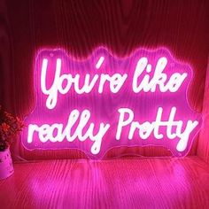 a pink neon sign that says you're like really potty on the table