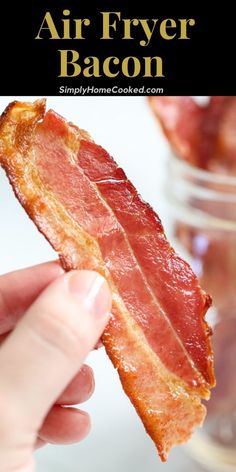 bacon is being held up to the camera with text overlay that reads air fryer bacon