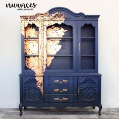 an old china cabinet is painted blue and gold