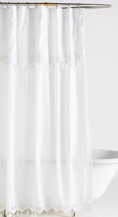 a white shower curtain with ruffled edges