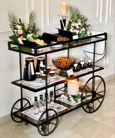 a bar cart with drinks and snacks on it