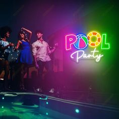 people standing in front of a neon pool party sign