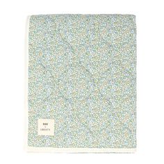 a blue and white flowered blanket with the words,'little flowers'on it