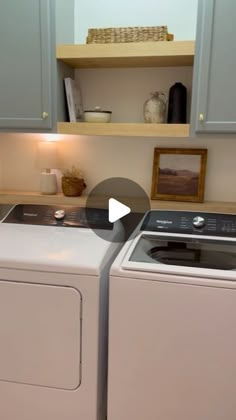 a washer and dryer sitting next to each other in a room with blue cabinets