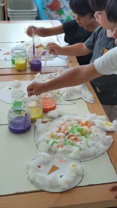 children are painting on paper plates with watercolors