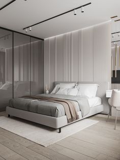 a bedroom with a bed, desk and chair next to a glass walled wall that has vertical slats on it