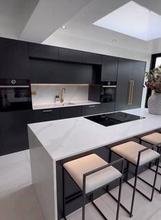 modern kitchen with white countertops and black cabinets