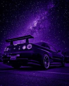 a car parked on the side of the road under a night sky filled with stars