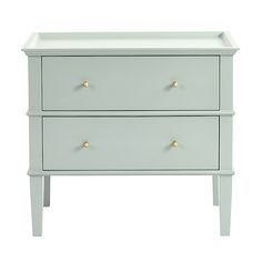 a white dresser with two drawers and gold knobs on the bottom, against a white background