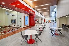 the inside of a building with tables and chairs