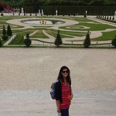 a woman standing in front of a large garden