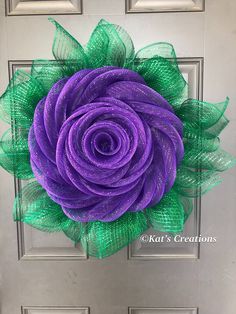 a purple and green flower on a door