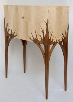 a wooden table with trees cut out of it's sides and the top section