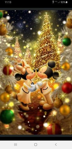 mickey and minnie kissing in front of christmas trees