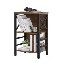 a book shelf with books on top of it and a plant in the corner next to it