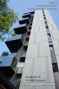 the side of a tall building with windows and balconies