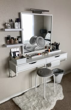 there is a vanity with a mirror and stool in the corner, along with other items