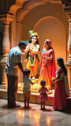 a group of people standing in front of a statue with candles on the ground next to it