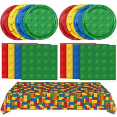 a table topped with lots of different colored plates and place mats covered in legos