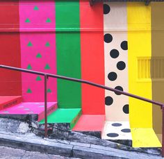 the stairs are painted with different colors and designs on them, along with black dots