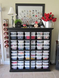 a shelf filled with lots of plastic containers and mickey mouse figurines on top of it