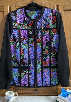 a black jacket with purple flowers on it