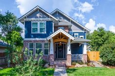 a blue house in the middle of a green yard