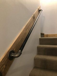 a set of stairs with metal handrails and wood treading in a home