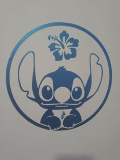 a blue and white sticker depicting an elephant with a flower on its head in a circle